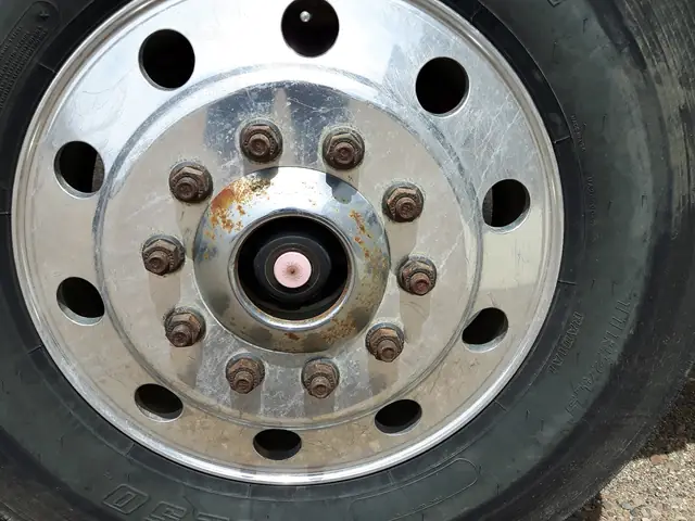 Dull, oxidized aluminum steer wheel before polishing