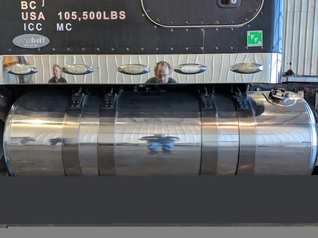 Mirror polished aluminum fuel tanks on a black truck